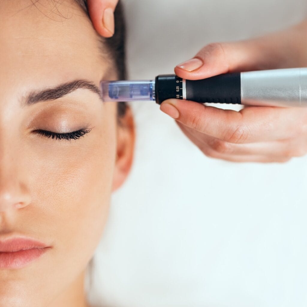 Cosmetologist making mesotherapy injection with dermapen on face for rejuvenation on the spa center.